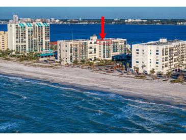 Aerial view of beachfront condo building with ocean and city views at 1400 Gulf Blvd # 801, Clearwater Beach, FL 33767