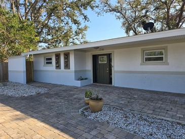 Charming single-story home with a brick driveway and stucco exterior with pleasing landscaping and neutral color scheme at 2746 Hibiscus St, Sarasota, FL 34239