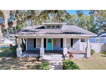 Gray house with a teal door, white columns, and a front porch at 606 N Merrin St, Plant City, FL 33563