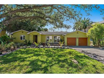 Green house with landscaping, two-car garage, and spacious lawn at 808 Monterey Ne Blvd, St Petersburg, FL 33704