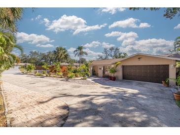 Attractive single-Gathering home with landscaped front yard and paver driveway at 1426 Jasmine Ct, Clearwater, FL 33756