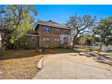 Two-story house with a large front yard and a long driveway at 1530 22Nd S Ave, St Petersburg, FL 33705