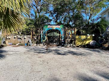 Quaint property entrance with unique gate and landscaping at 3022 56Th S St, Gulfport, FL 33707