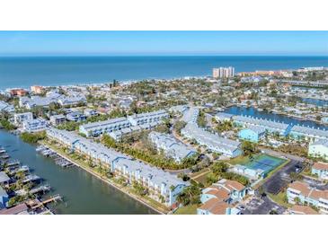 Aerial view of waterfront community with tennis courts and private docks at 514 Garland Cir, Indian Rocks Beach, FL 33785