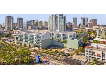 Aerial view of a modern condo building in a vibrant city setting at 912 Channelside Dr # 2320, Tampa, FL 33602
