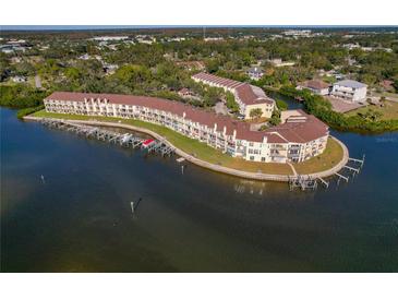 Aerial view of waterfront condo community with boat slips and lush landscaping at 115 Brent Cir, Oldsmar, FL 34677