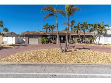 Charming single-story home with a brick driveway and palm trees at 2260 E Vina Del Mar Blvd, St Pete Beach, FL 33706