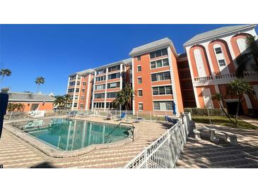 Community pool with surrounding patio and building view at 6960 20Th N Ave # 501, St Petersburg, FL 33710