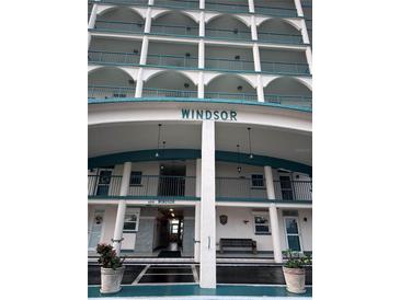 Windsor building exterior, featuring multiple balconies and a covered entrance at 6020 Shore S Blvd # 301, Gulfport, FL 33707