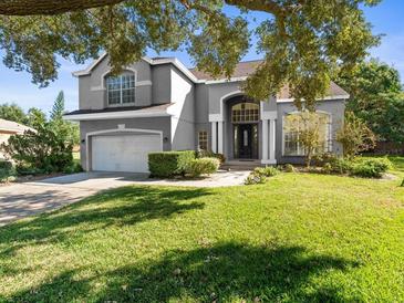 Two-story house with attached garage and manicured lawn at 9701 Hidden Cove Ct, Tampa, FL 33618