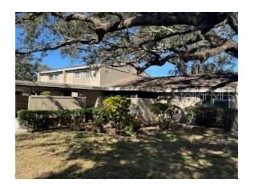 Exterior view of condo with mature landscaping at 8631 Cattail Dr # 146, Temple Terrace, FL 33637