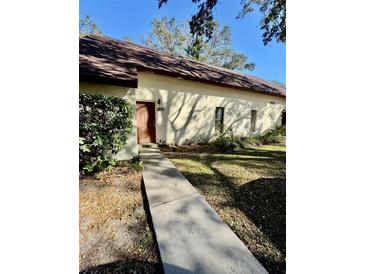 Well maintained house exterior with a walkway leading to the entrance at 12315 Touchton Dr # 90, Tampa, FL 33617