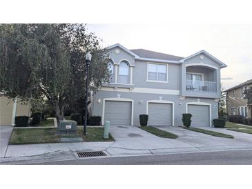 Two-story townhome with three-car garage and balcony at 9060 Moonlit Meadows Loop, Riverview, FL 33578