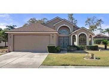 One-story house with a two-car garage and well-maintained lawn at 13745 Pimberton Dr, Hudson, FL 34669