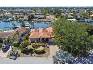 Waterfront home with lush landscaping, private dock, boat and beautiful terracotta roof at 1997 Kansas Ne Ave, St Petersburg, FL 33703