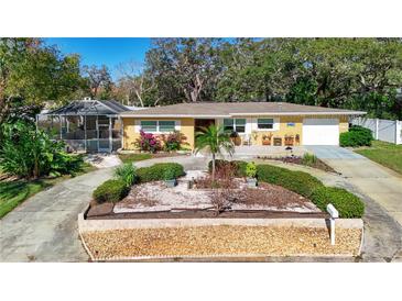 Attractive single-story home with landscaped yard and circular driveway at 209 Westwinds Dr, Palm Harbor, FL 34683