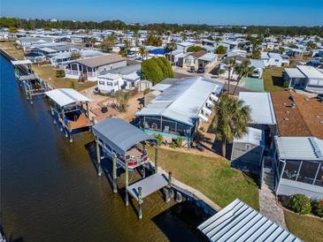 An aerial view of waterfront homes and boat docks on a sunny day at 110 W Saint Annes Cir, Apollo Beach, FL 33572