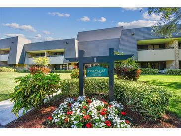 Pine Valley Lodge condo building with landscaping and signage at 36750 Us Highway 19 N # 19219, Palm Harbor, FL 34684