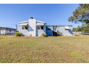 Single-story home with a spacious yard, and carport at 4043 Fox Ridge Blvd, Wesley Chapel, FL 33543