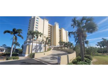 Elegant high-rise building with palm trees and landscaping at 10851 Mangrove Cay Ne Ln # 1112, St Petersburg, FL 33716