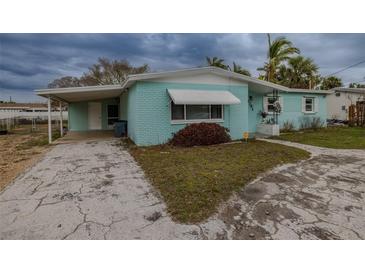 Charming light blue single story home with carport and mature landscaping at 3781 Belle Vista E Dr, St Pete Beach, FL 33706