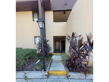 Exterior view showing building entrance with landscaping at 760 S Village N Dr # 103, St Petersburg, FL 33716