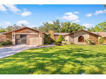 Single-story house with attached garage and spacious lawn at 8069 Pagoda Dr, Spring Hill, FL 34606