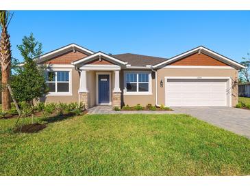 One-story home with two-toned exterior, landscaping, and a two-car garage at 12354 54Th E St, Parrish, FL 34219