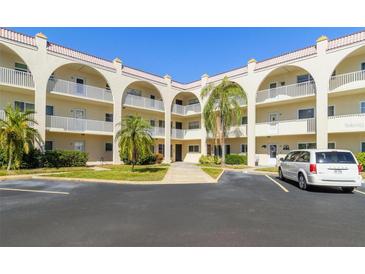 Front view of a two-story condo building with parking and landscaping at 2258 World Parkway W Blvd # 12, Clearwater, FL 33763