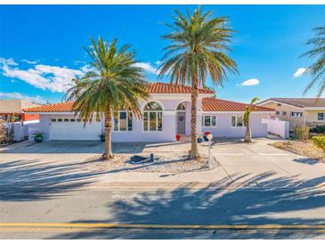 Attractive waterfront home with palm trees and red tile roof at 600 55Th Ave, St Pete Beach, FL 33706