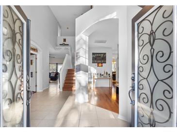 Two-story entryway with an open staircase and hardwood floors at 18127 Sandy Pointe Dr, Tampa, FL 33647