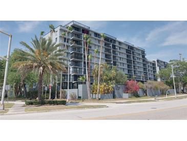 Exterior view of a multi-story building with palm trees and landscaping at 201 W Laurel St # 503, Tampa, FL 33602
