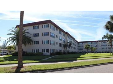 Tan multi-story condo building with lush landscaping and ample parking at 9950 62Nd N Ter # 316, St Petersburg, FL 33708