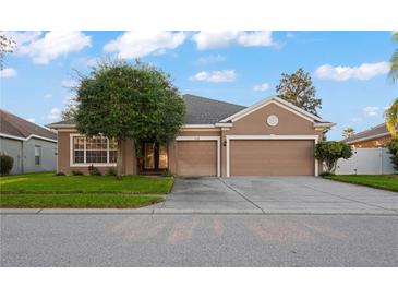 Charming single-story home featuring a well-maintained lawn and a two-car garage in a tranquil neighborhood at 11240 Ragsdale Ct, New Port Richey, FL 34654