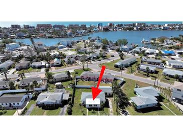 Aerial view showing a single-story home near the water at 14140 E Parsley Dr, Madeira Beach, FL 33708