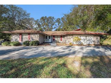 Brick ranch home with mature landscaping and a large driveway at 4609 Horton Rd, Plant City, FL 33567