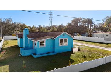 Charming light blue house with a spacious yard and detached garage at 1900 W Norfolk St, Tampa, FL 33604