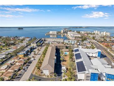 Aerial view of waterfront property showing building, pool, and surrounding area at 460 Paula S Dr # 101, Dunedin, FL 34698