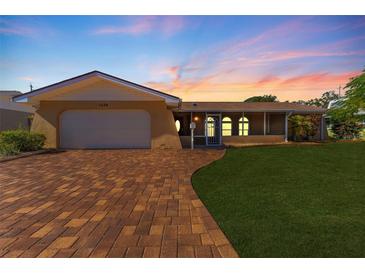 Inviting home with a brick paver driveway and well-manicured lawn at 1534 W Del Webb Blvd, Sun City Center, FL 33573