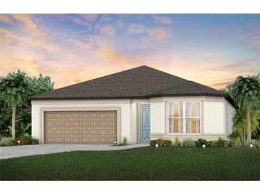 One-story home with brown roof, beige walls, and a two-car garage at 3952 Big Sky Dr, Spring Hill, FL 34604