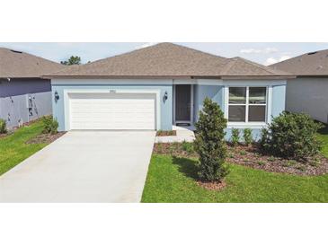 Charming single-story home with a well-manicured lawn and a two-car garage at 3952 Big Sky Dr, Spring Hill, FL 34604
