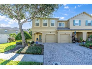 Two-story townhome with two-car garage and landscaping at 17530 Stinchar Dr, Land O Lakes, FL 34638