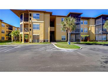 Condo building with parking and tropical landscaping at 4323 Bayside Village Dr # 327, Tampa, FL 33615