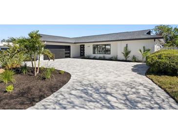 Updated mid-century modern home with a new roof, driveway, and landscaping at 475 Island Way, Clearwater Beach, FL 33767