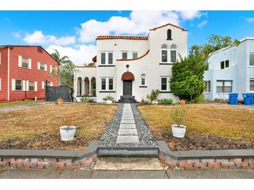 Charming Spanish-style home with a stone pathway leading to the entrance at 671 Jasmine S Way, St Petersburg, FL 33705