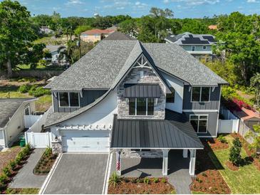 Stunning two-story home featuring stone accents, covered entry, and a beautifully landscaped front yard at 3509 W Leona St, Tampa, FL 33629