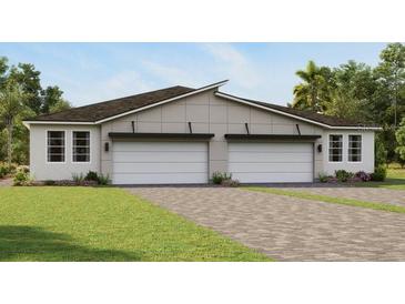 Modern two-unit building with attached garages and attractive landscaping at 6168 Timberdale Ave, Wesley Chapel, FL 33545