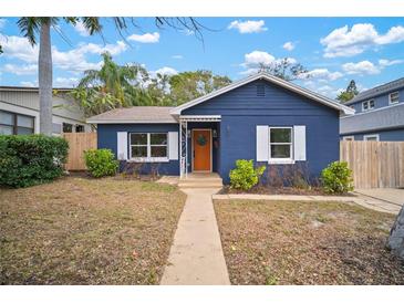 Charming blue house with a landscaped yard and walkway at 851 16Th S Ave, St Petersburg, FL 33701