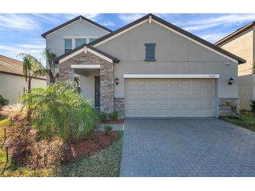 Two-story house with stone accents and a two-car garage at 11321 Chilly Water Ct, Riverview, FL 33569