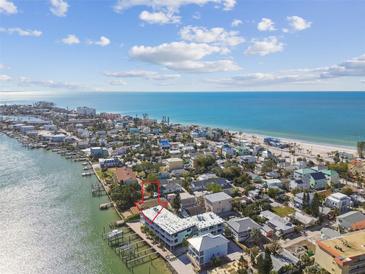 Aerial view of waterfront property with boat slips and beach access at 143 94Th Treasure Island Ave # 2, Treasure Island, FL 33706